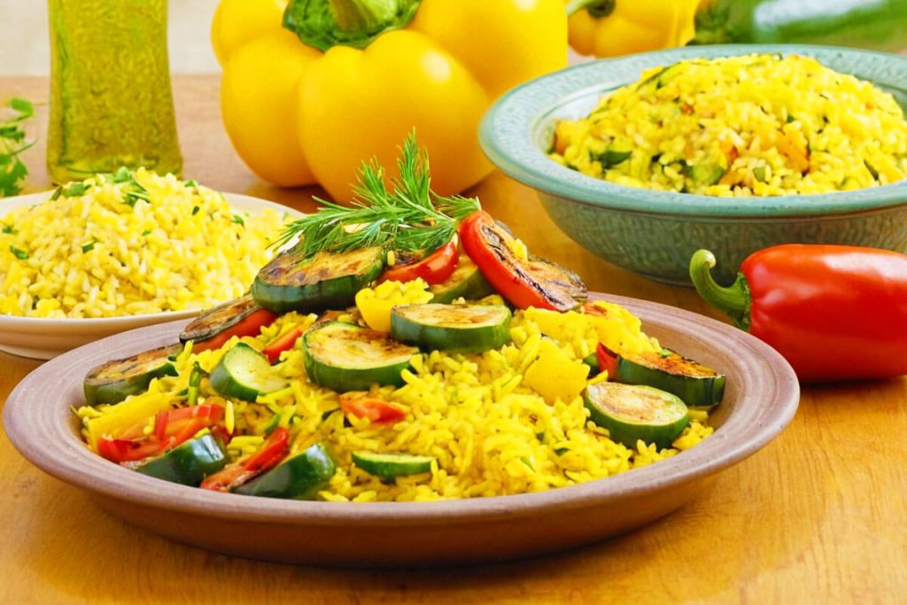 Grilled vegetables with fluffy yellow rice.