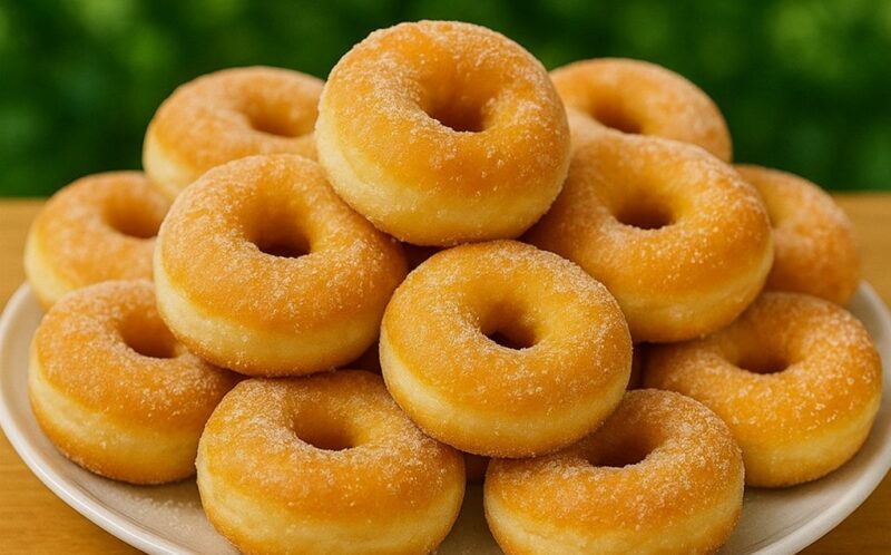Freshly baked fluffy donut breads dusted with powdered sugar on a cooling rack