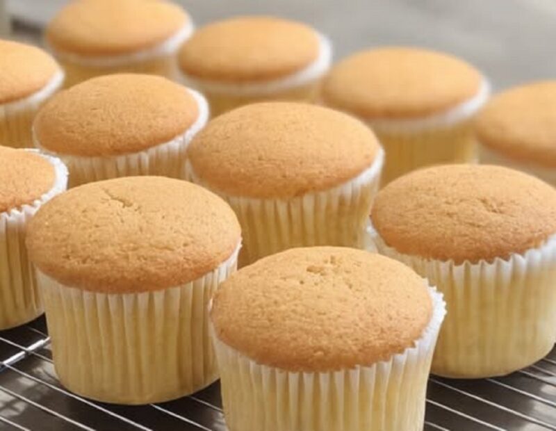 Fluffy milk cupcakes on cooling rack