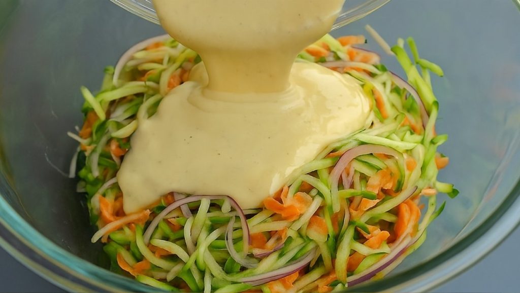 Golden zucchini patties stacked on a plate