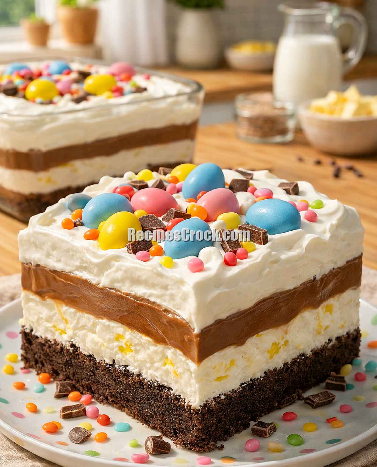 Easter chocolate lasagna dessert with layers of Oreo crust, cheesecake, chocolate pudding, and whipped topping decorated with pastel candy eggs